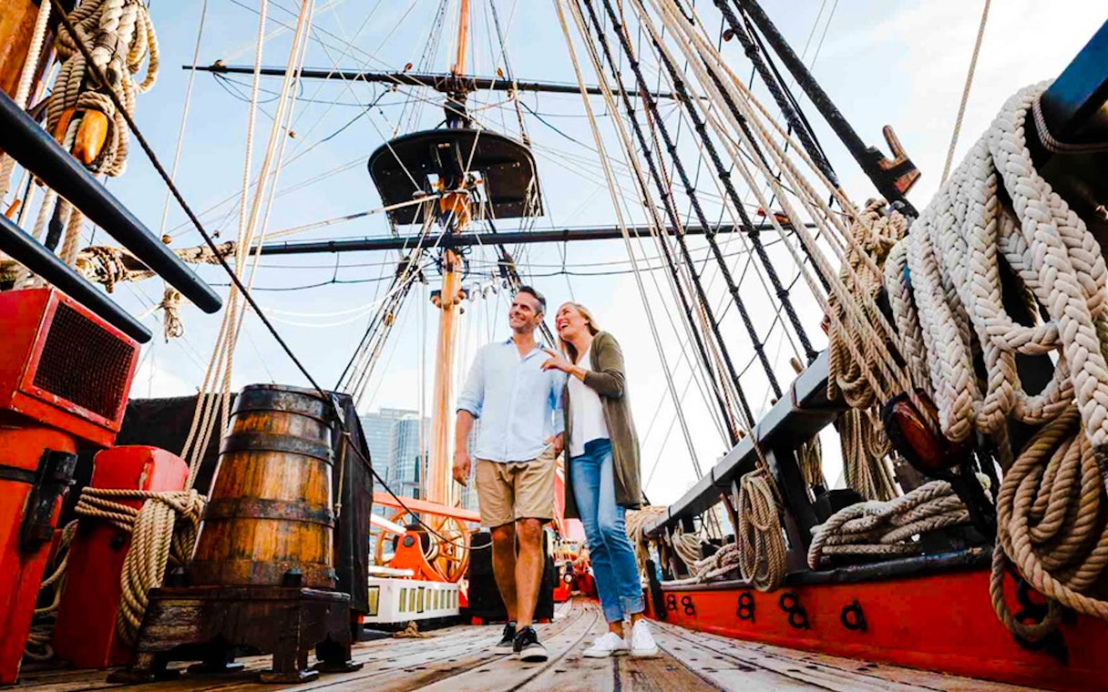Couple exploring historic ship at Australian National Maritime Museum, Sydney.