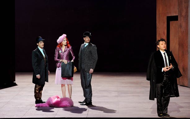 Performers on stage in a scene from "Yvonne, Princesse de Bourgogne" with elegant costumes.