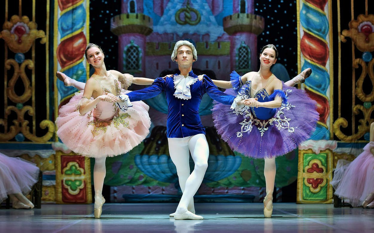 Ballet dancers performing on stage with colorful costumes and a castle backdrop, Stars of Russian Ballet.