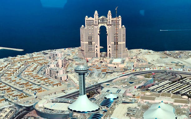 Aerial view of Abu Dhabi skyline with modern architecture near the coast, seen during a seaplane tour.