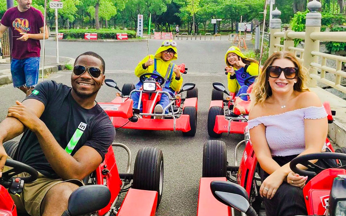Participants enjoying Akiba Kart Osaka street go-karting in colorful costumes.