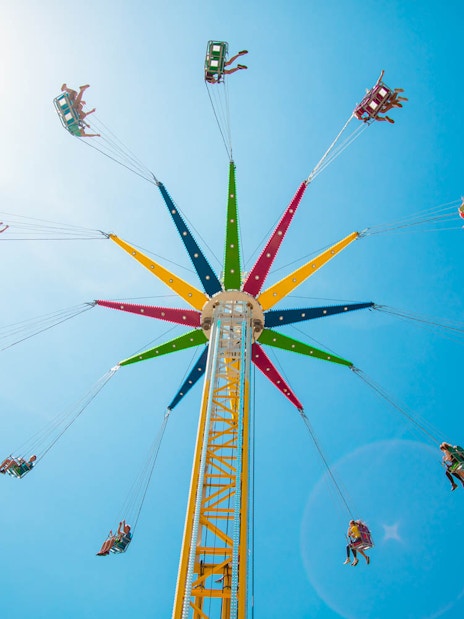 Visitors enjoying a colorful swing ride at Gold Coast Sea World.