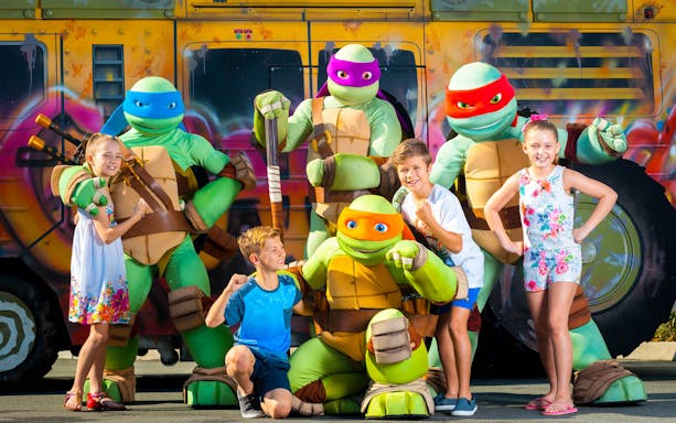 Children posing with turtle characters at Gold Coast Sea World.