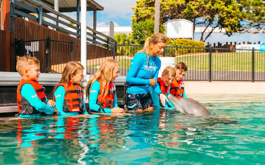 Children interacting with a dolphin at Gold Coast Sea World.