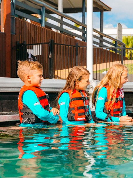 Children interacting with a dolphin at Gold Coast Sea World.