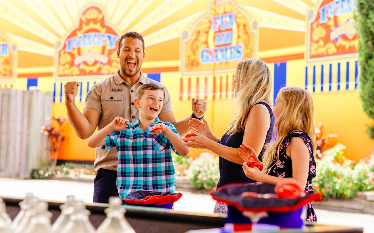 Family enjoying games at Warner Brothers Movie World.