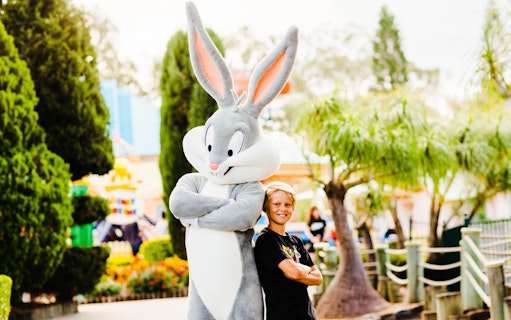 Boy posing with Bugs Bunny character at Warner Brothers Movie World.