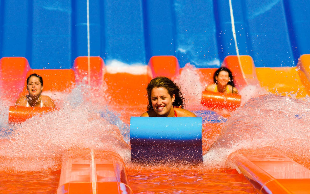 Visitors enjoying water slides at Wet 'n' Wild with Single Day Pass.