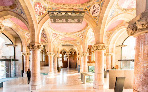 Sant Pau Art Nouveau interior with ornate arches and columns during guided tour.