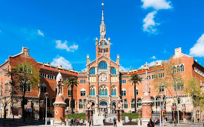 Sant Pau Art Nouveau site in Barcelona with intricate architecture and palm trees.