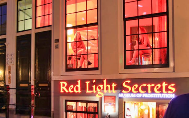 Red Light Secrets Museum entrance with illuminated sign in Amsterdam.