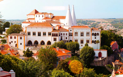 National Palace of Sintra with iconic chimneys and surrounding landscape.