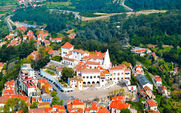 Aerial view of the National Palace of Sintra with surrounding landscape in Portugal.