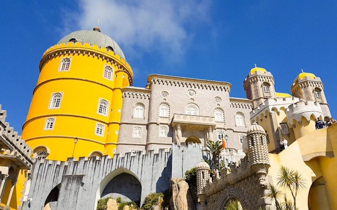 National Palace of Pena in Sintra with vibrant yellow towers and intricate architecture.