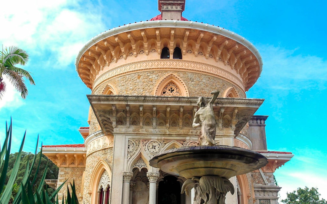 Monserrate Palace facade with ornate stonework and fountain, Sintra, Portugal.