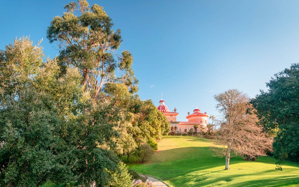 Monserrate Palace in Sintra surrounded by lush gardens and trees.