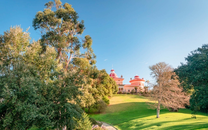 Monserrate Palace in Sintra surrounded by lush gardens and trees.