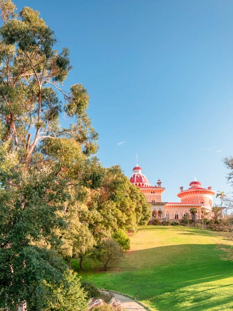 Monserrate Palace in Sintra surrounded by lush gardens and trees.