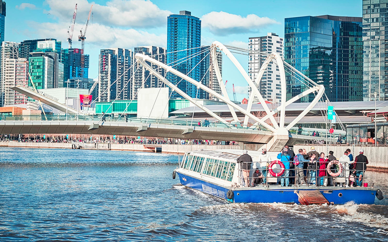 Melbourne river cruise showcasing city skyline and Docklands, highlighting Ports and Docklands tour experience.