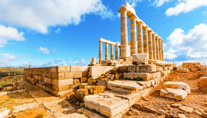 Temple of Poseidon at Cape Sounion during sunset, part of a guided tour from Athens.