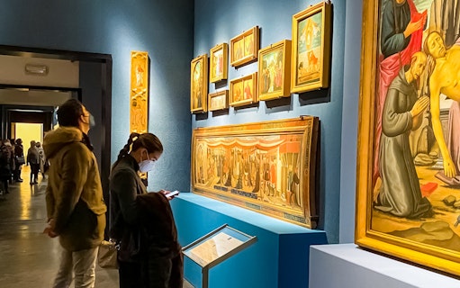 Visitors viewing Renaissance paintings at the Accademia Gallery, Florence.