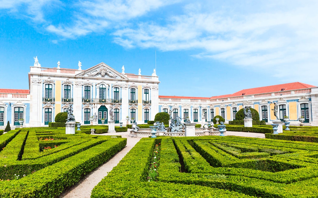 National Palace of Queluz with manicured gardens and statues in Portugal.