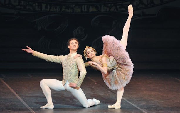 Ballet dancers performing Raymonda on stage.