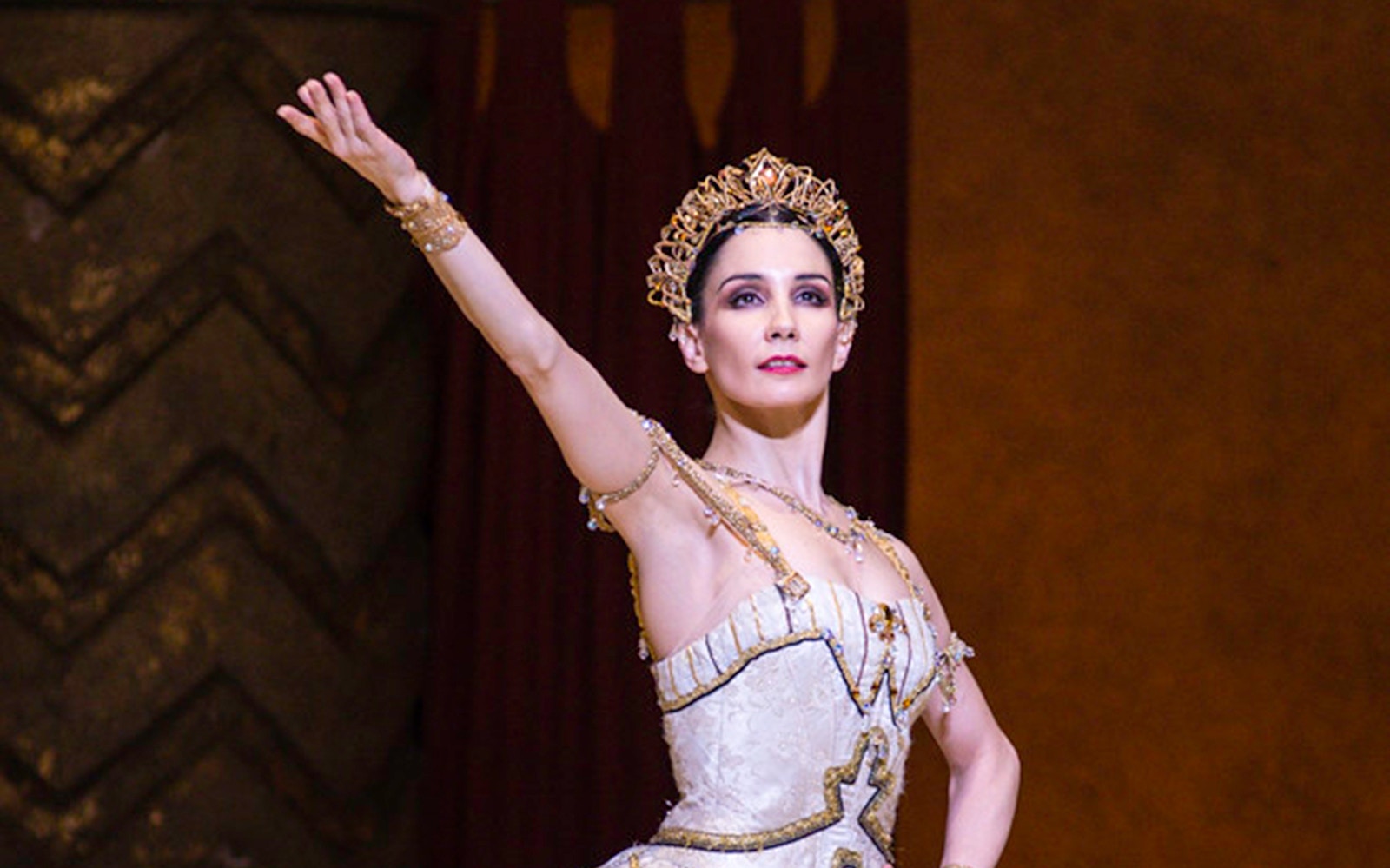 Ballet dancer performing Raymonda in ornate costume.