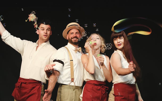 Performers blowing bubbles during "The Imbible: A Spirited History of Drinking" show.