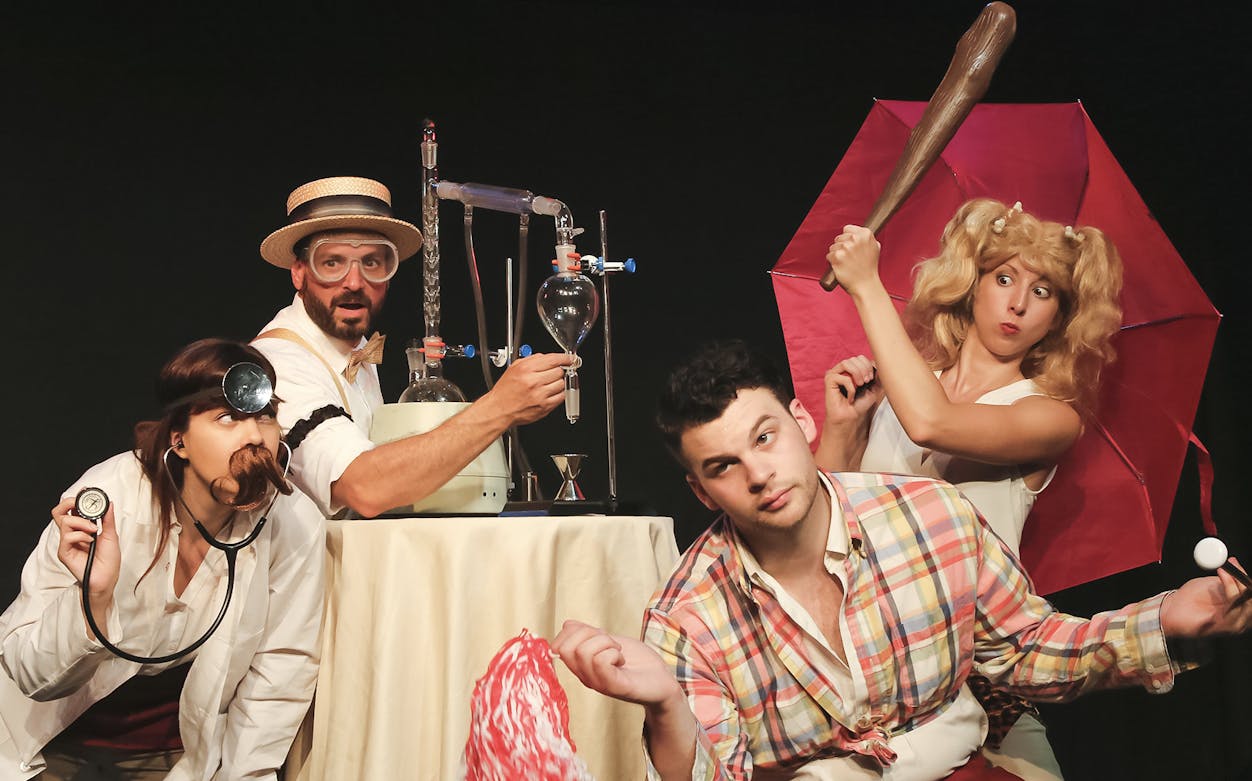 Performers in a comedic scene from The Imbible: A Spirited History of Drinking, featuring lab equipment.