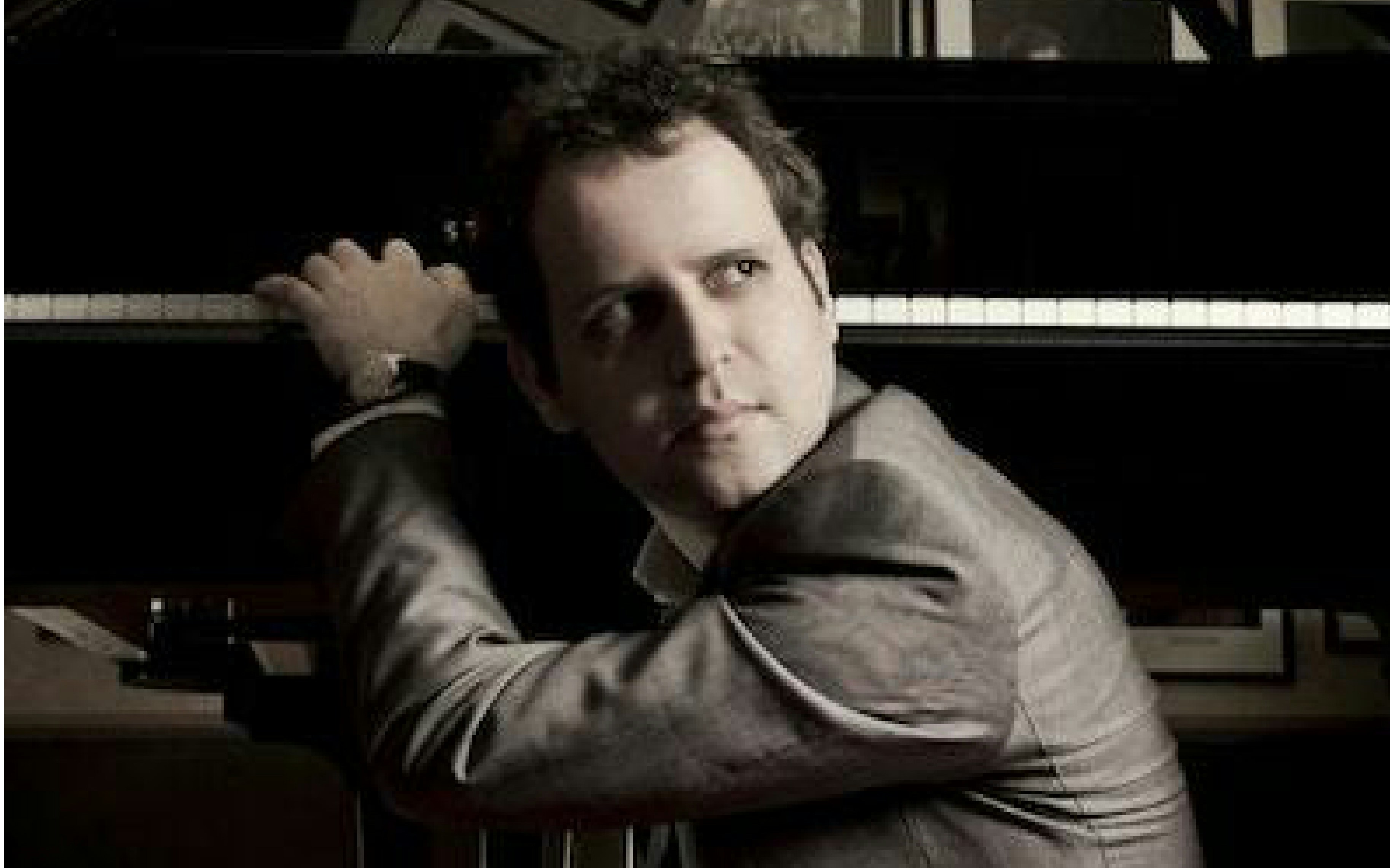 Author seated at a piano, related to "Adam Kay: This Is Going to Hurt" event.