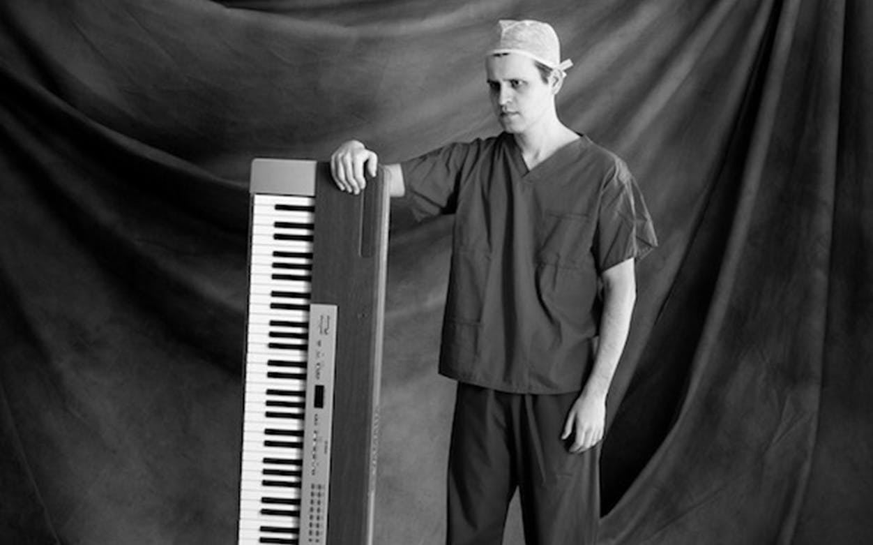 Man in scrubs with a keyboard, related to "Adam Kay: This Is Going to Hurt" tour.