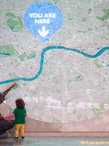 Man and child looking at large map display at London Transport Museum.