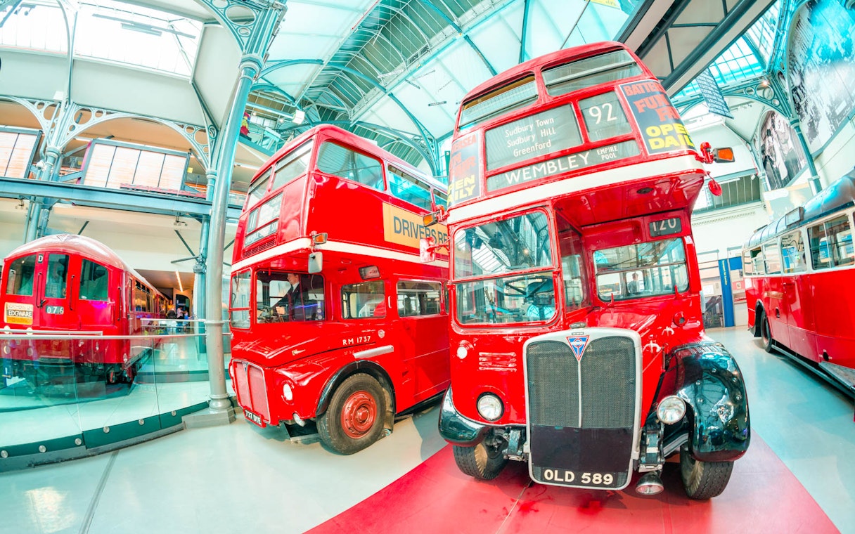 Vintage red buses displayed at the London Transport Museum.