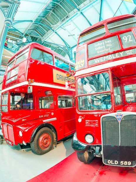 Vintage red buses displayed at the London Transport Museum.