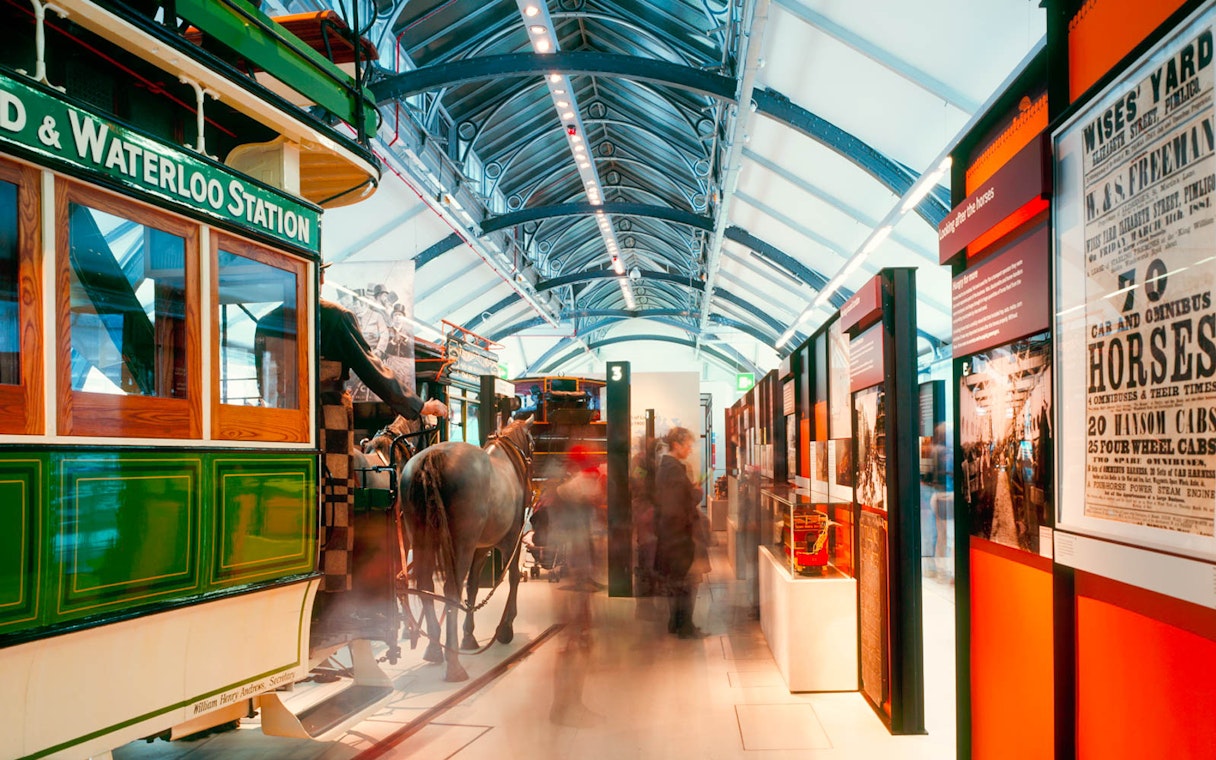 Horse-drawn carriage exhibit at London Transport Museum, showcasing historical transportation methods.