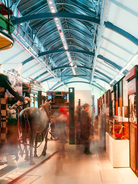 Horse-drawn carriage exhibit at London Transport Museum, showcasing historical transportation methods.