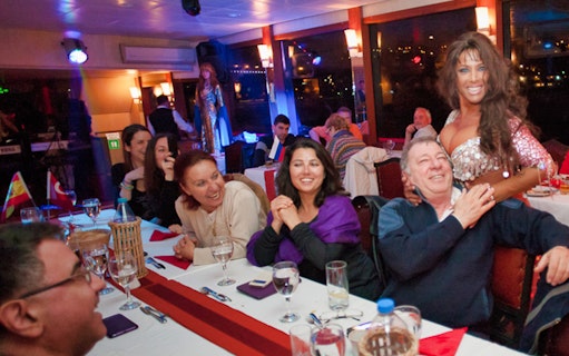 Guests enjoying live entertainment on a Bosphorus dinner cruise in Istanbul.