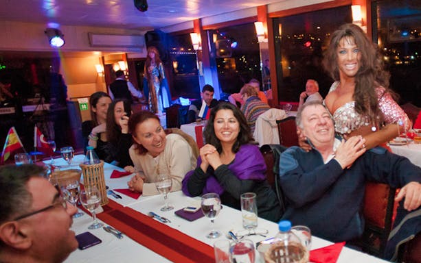 Guests enjoying live entertainment on a Bosphorus dinner cruise in Istanbul.