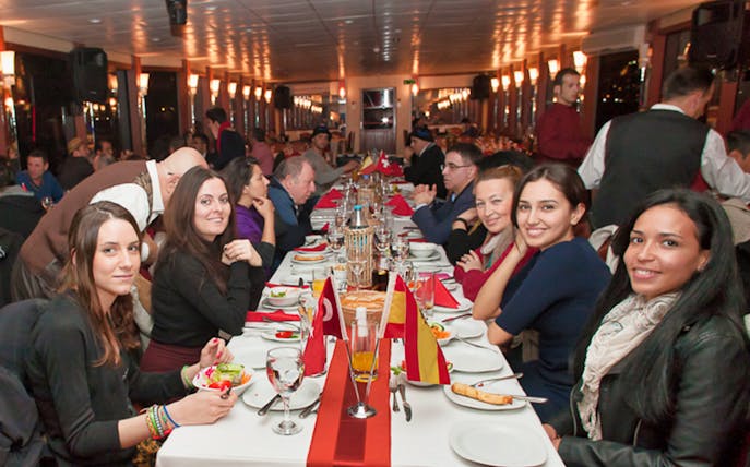 Guests enjoying a dinner cruise on the Bosphorus with Turkish night shows.