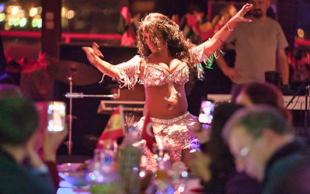Belly dancer performing on Bosphorus dinner cruise with live audience.