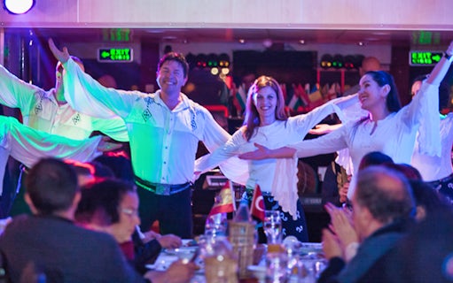 Dancers performing on a Bosphorus dinner cruise with guests dining.