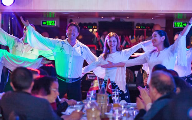 Dancers performing on a Bosphorus dinner cruise with guests dining.