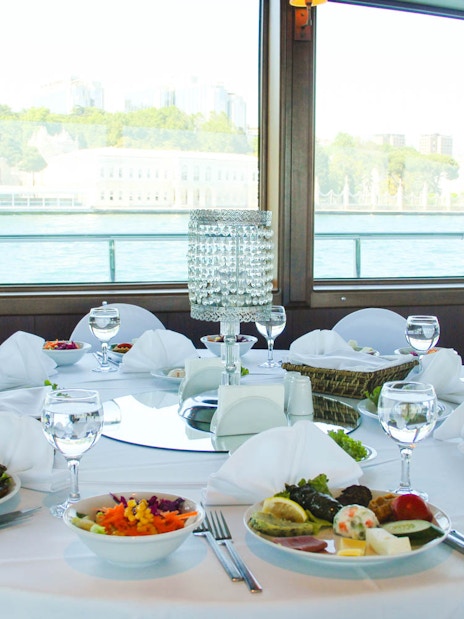 Lunch table set on Bosphorus cruise with view of the Black Sea.