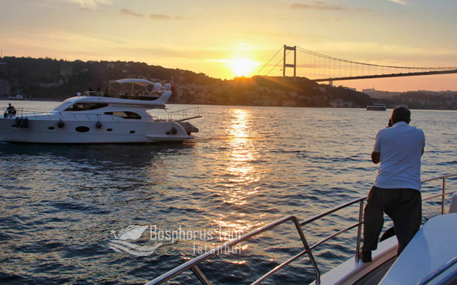 Sunset cruise on the Bosphorus with a view of the bridge in Istanbul.