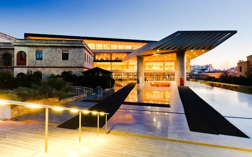 Acropolis Museum entrance at dusk, Athens city tour.
