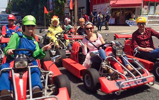Go-kart riders in costumes on a Tokyo street during Akihabara tour.