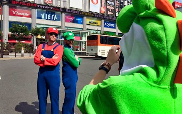 People in character costumes posing for a photo during a Tokyo Go-Kart tour in Akihabara.