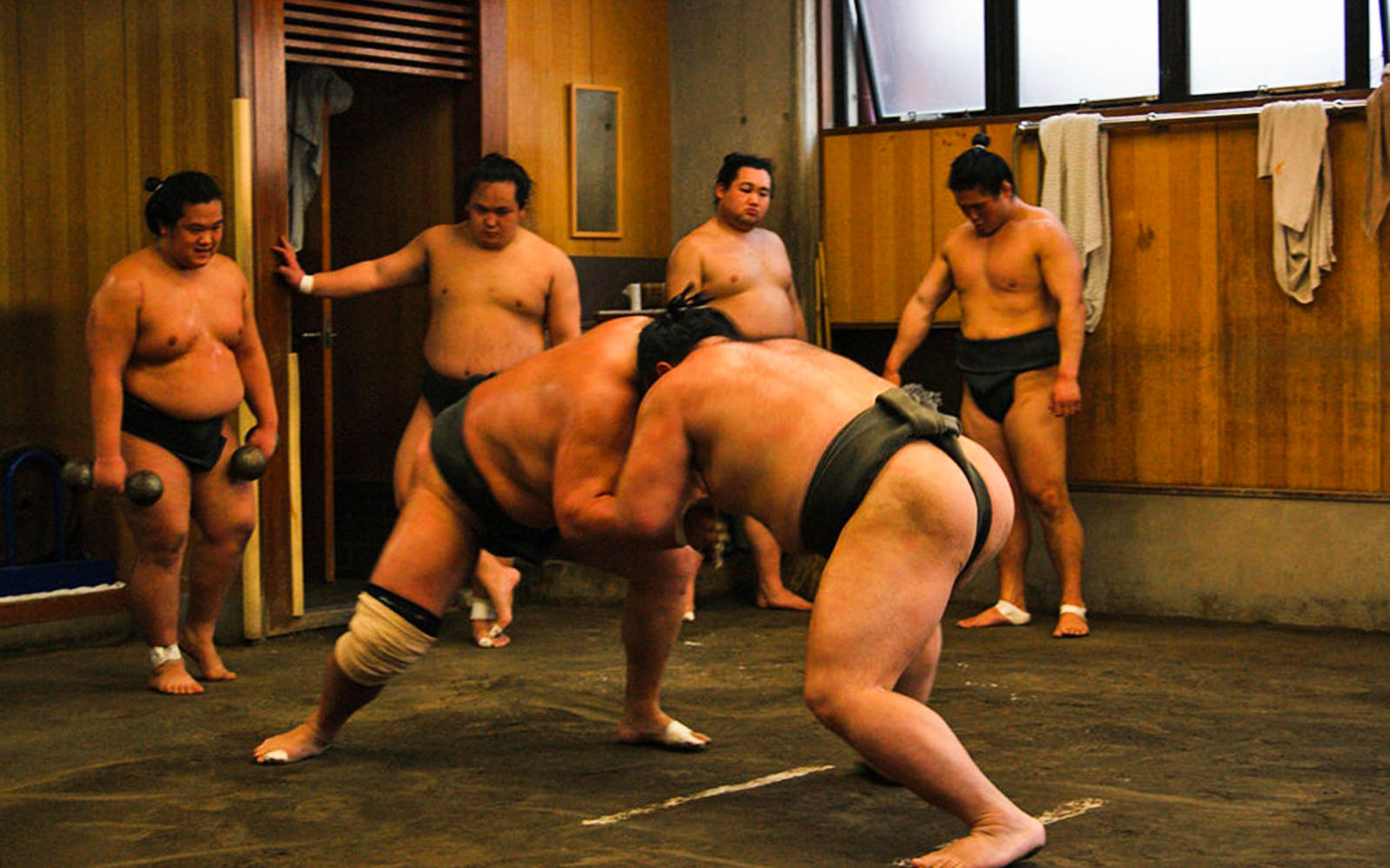 Sumo wrestlers practicing at a Tokyo sumo stable.