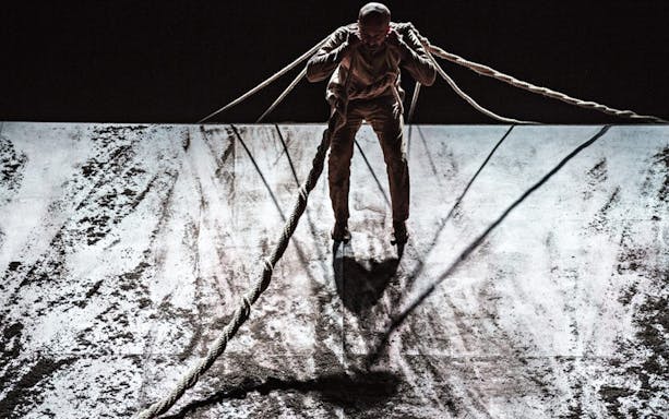 Performer with ropes in Akram Khan Company’s XENOS dance production.